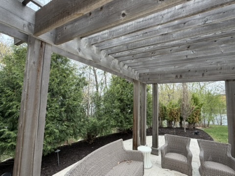 Mulched beds under a pergola patio